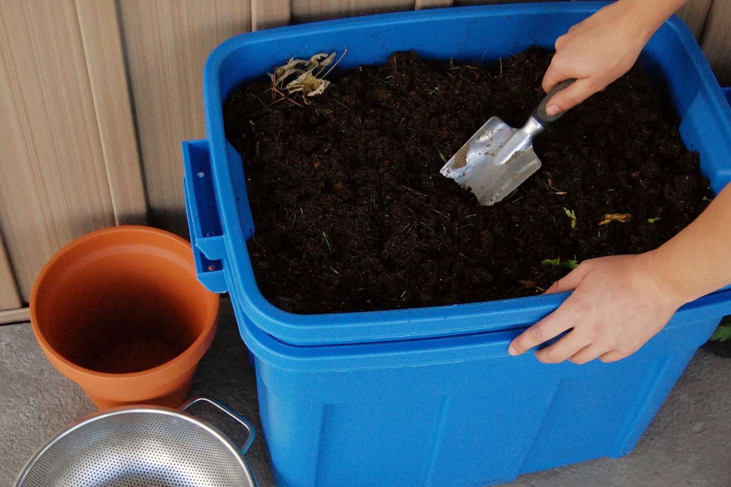 DIY compost bin made from wooden pallets with finished compost ready for garden beds