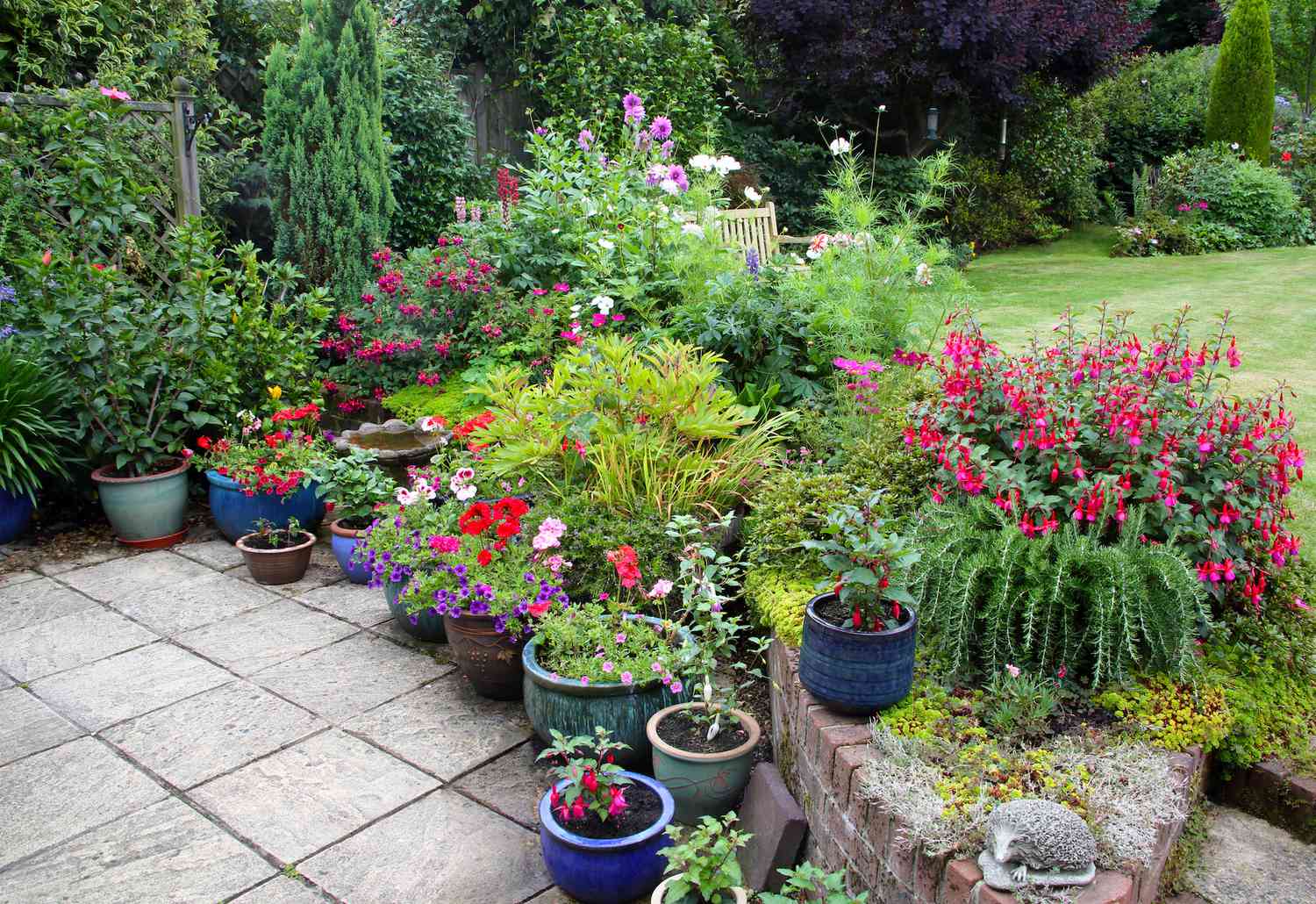 Raised garden beds with stone edging integrated into a residential landscape design